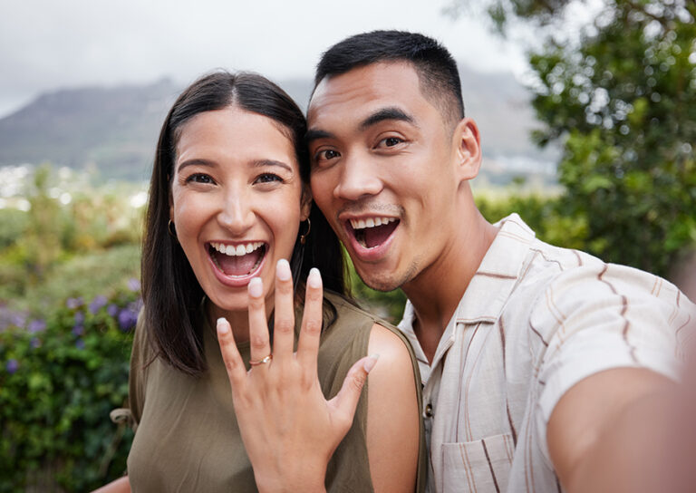 Closeup portrait of a man and woman taking a selfie after getting engaged to be married