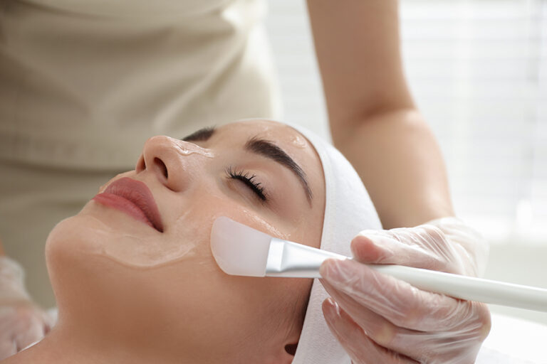 Young woman during face peeling procedure in a clinic