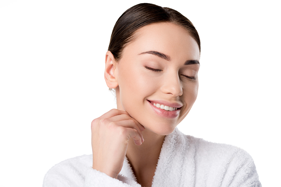 Beautiful Woman In Bathrobe With Eyes Closed Touching Face