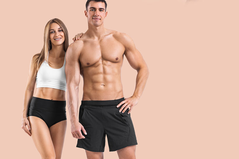 Fit couple at the gym isolated on light background