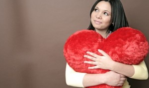 Woman holding a heart pillow