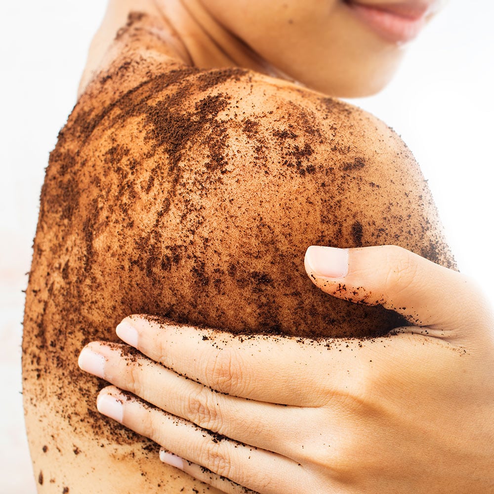 Woman With Coffee Scrub On Shoulder