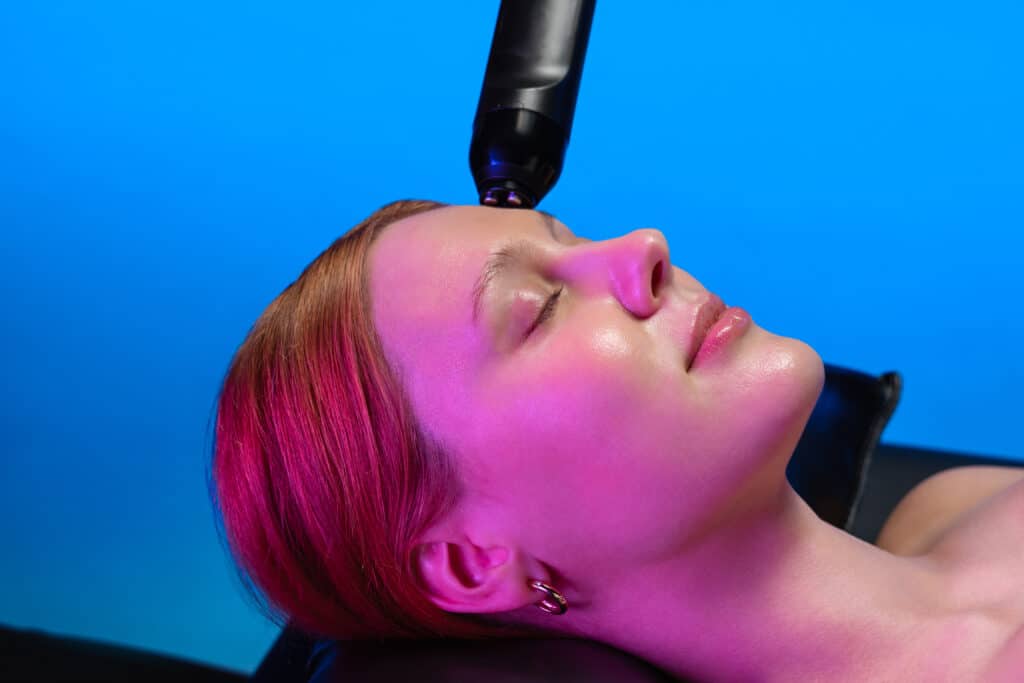 A Woman Getting A Face Treatment
